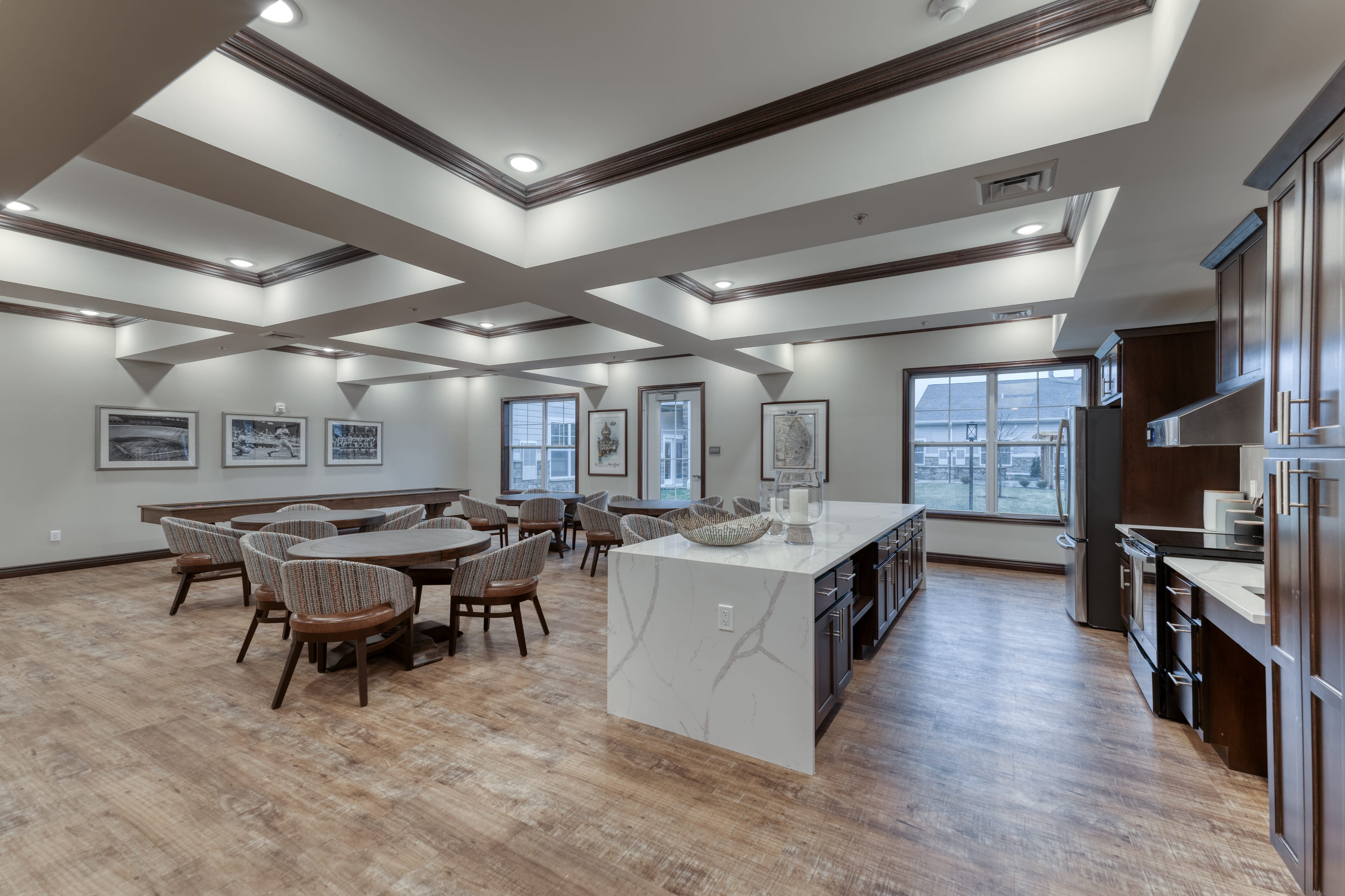 Round tables in this community room encourage residents to dine, socialize, or play games